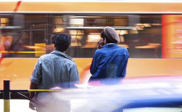 Sfocato giovani uomini in attesa alla fermata dell'autobus — Foto Stock