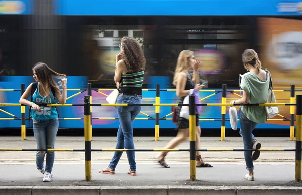 Vier junge Frauen an Bushaltestelle — Stockfoto