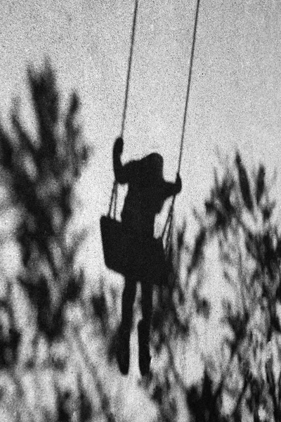 Girl on a swing shadow — Stock Photo, Image