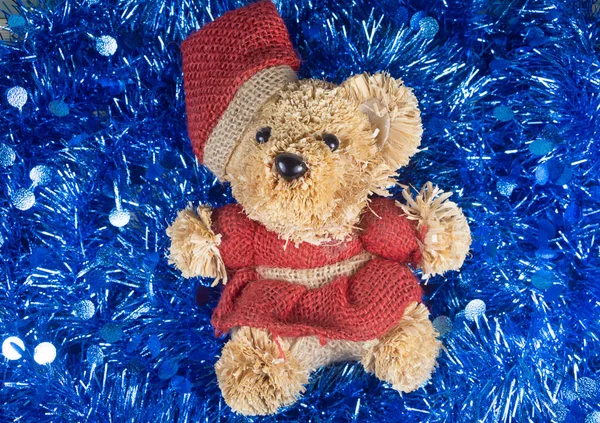 Teddy bear on blue tinsel — Stock Photo, Image