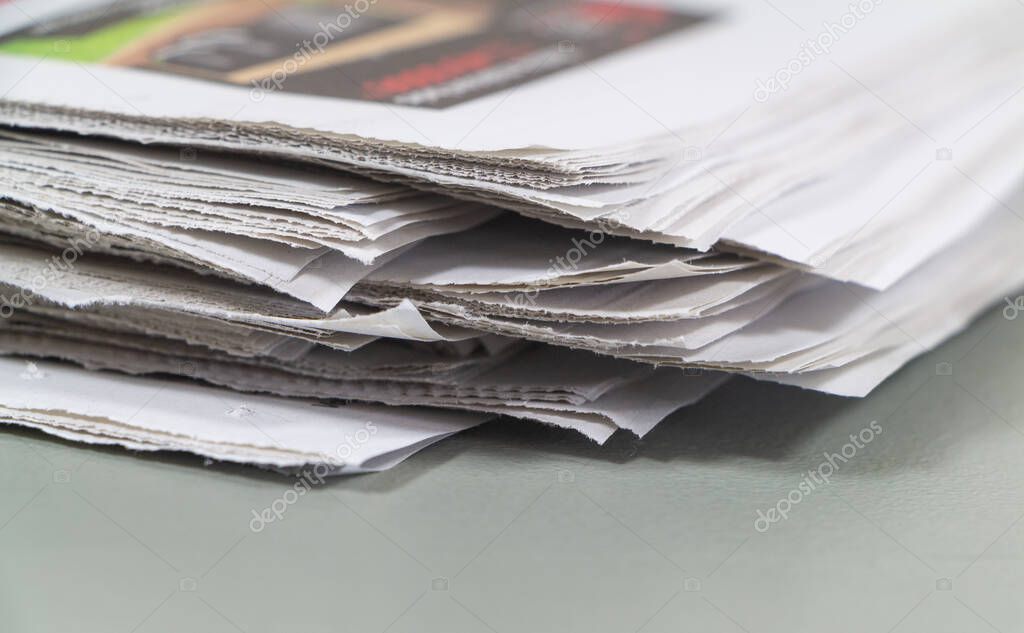 Pile of french newspapers on gray background