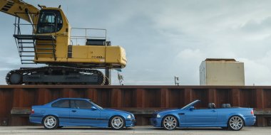 BMW M cars at a small harbor clipart