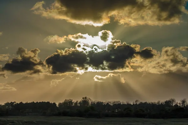 Nuvens escuras e alguns raios solares — Fotografia de Stock