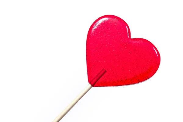 Lecca-lecca rosso a forma di cuore sullo sfondo bianco . — Foto Stock