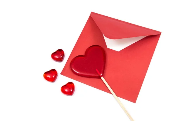 Red envelope and lollipops on the white background. — Stock Photo, Image