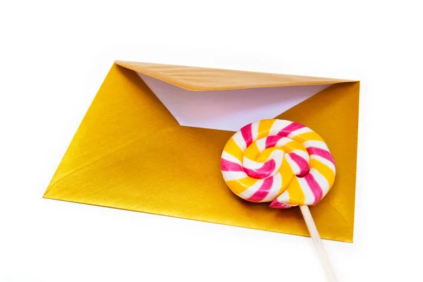 Open gold envelope and lollipop. — Stock Photo, Image