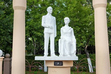 Sculptures of the famous russian poets Nikolai Gumilev and Anna Akhmatova in the park.  clipart