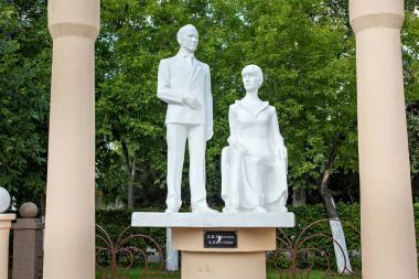 Sculptures of the famous russian poets Nikolai Gumilev and Anna Akhmatova in the park.  clipart