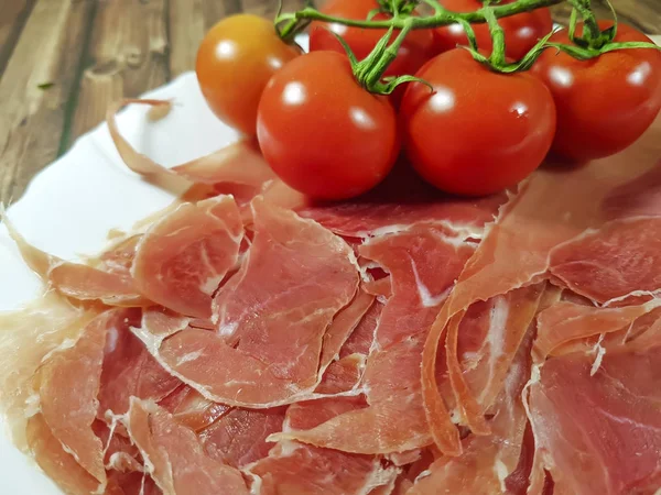 Jamon wooden board cherry tomato — Stock Photo, Image