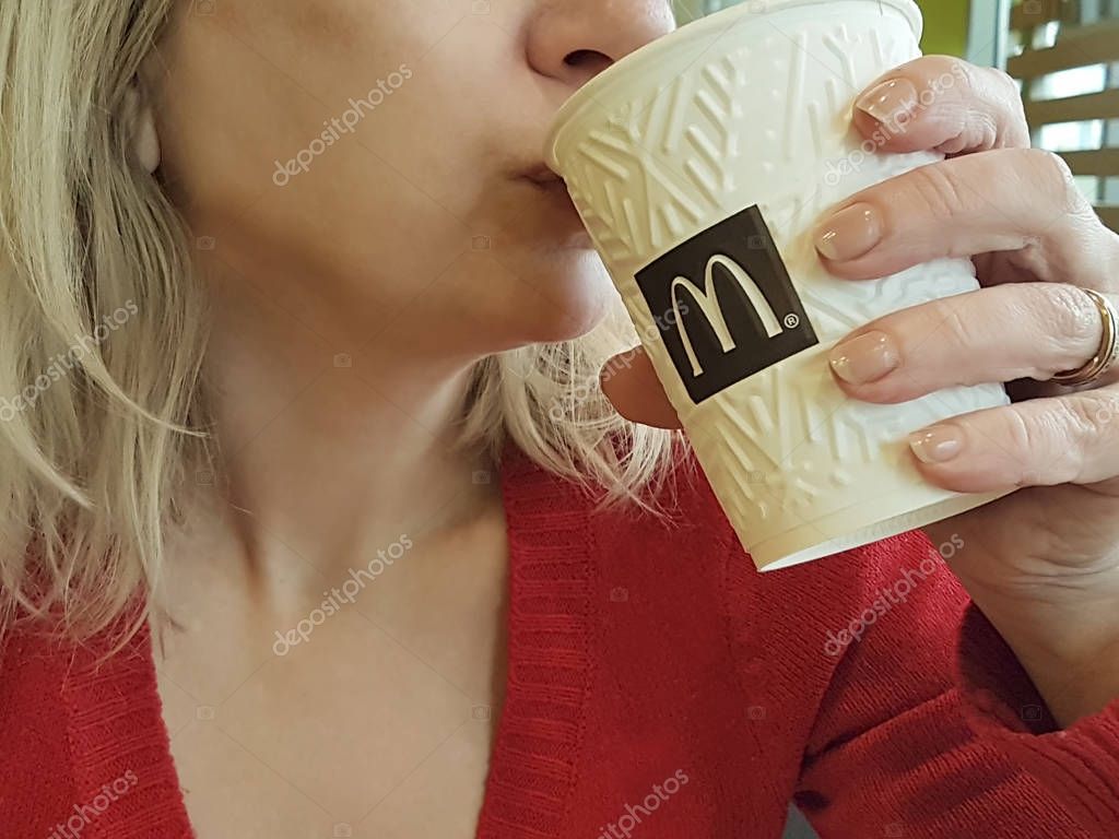 December 7, 2017 Ukraine Kiev cafe McDonald girl drinks coffee