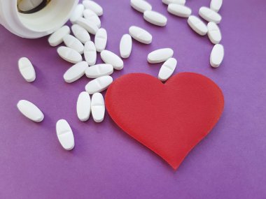 şişe ve beyaz tıbbi hap kalp arka plan üzerinde