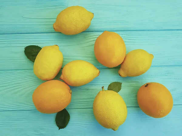 ripe orange lemon on a blue wooden background