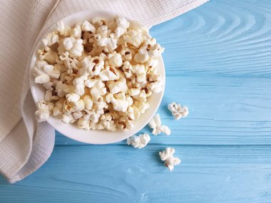 Mavi ahşap havlu üzerinde patlamış mısır