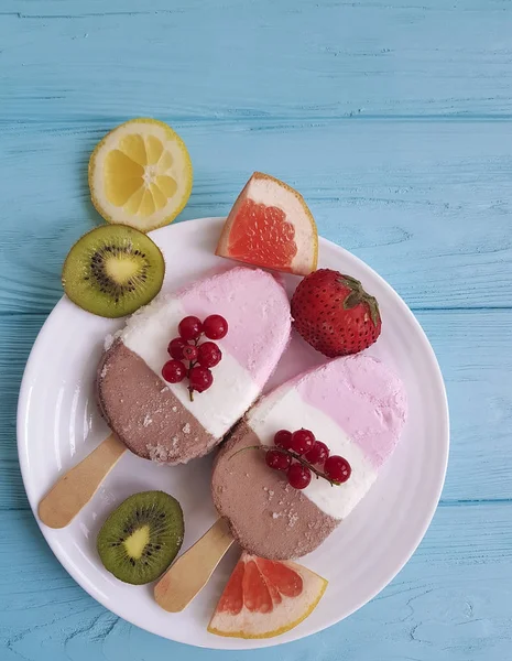 ice cream with red currant on blue wooden, grapefruit