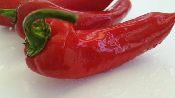 Red Green Pepper White Background Pouring Water — Stock Video