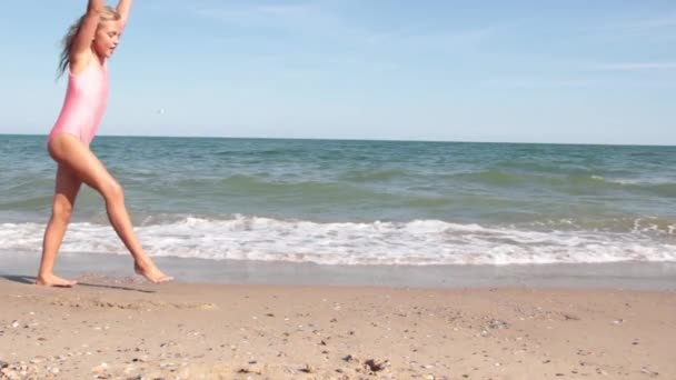 Kleines Mädchen Badeanzug Strand Schlägt Purzelbäume — Stockvideo