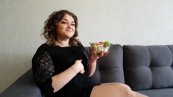 beautiful full girl with salad on the sofa happy, 