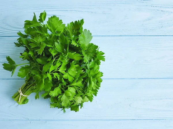 parsley fresh on a blue wooden background