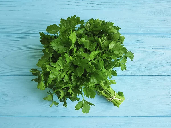 parsley fresh on a blue wooden background
