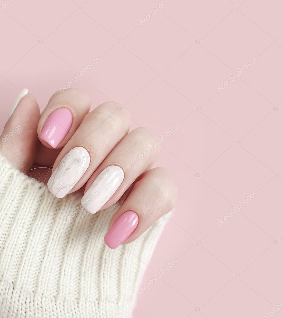 female hand beautiful manicure sweater