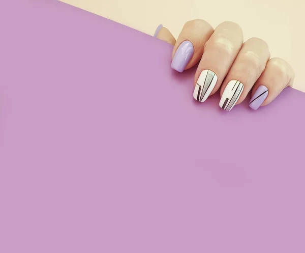 female hand nail manicure on a colored background