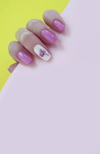 female hand nail beautiful manicure on a colored background