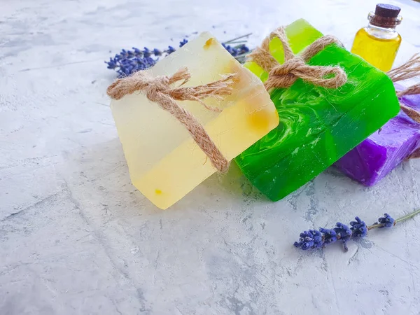 cosmetic soap, oil lavender flower on concrete background