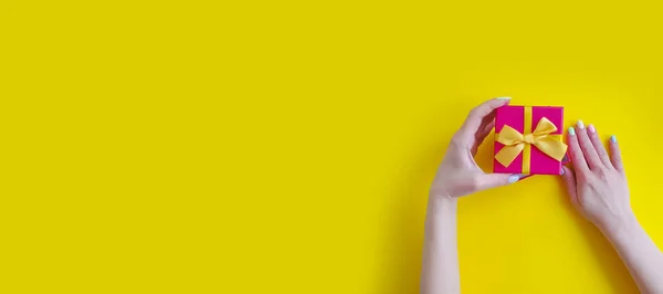 Kadın Elleri Renkli Bir Arka Planda Hediye Kutusunu Tutuyor — Stok fotoğraf