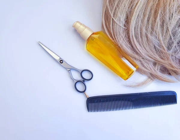 female hair, oil, comb, scissors