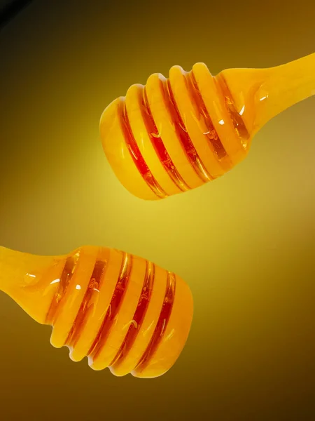 stock image Honey wooden dipper, on yellow background