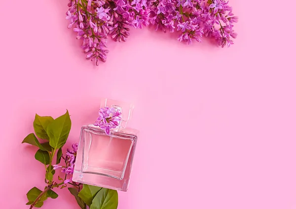 bottle perfume flower lilac on a colored background