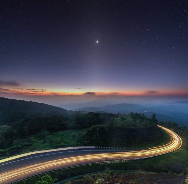 doğa gündoğumu arka plan şaşırtıcı eğri yol ve zodiacal ışık yıldız gece gökyüzü alacakaranlık rengi uzun pozlama görünümü. Popüler gezi dağ Doi Inthanon yol km41 Chiang Mai province Tayland