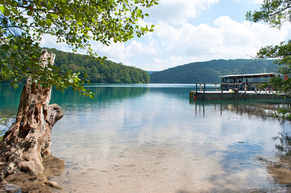 A boat at the wooden quay at the Kozjak lake