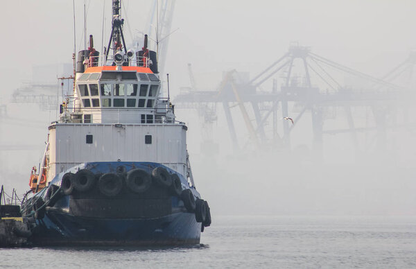 The tug is at the pier in the seaport