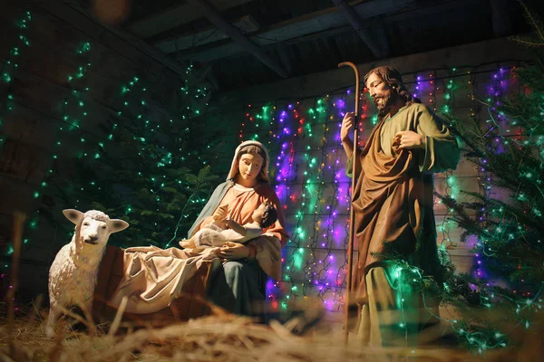 Christmas Manger scene with figures including Jesus, Mary, Joseph, sheep and magi. Christmas background