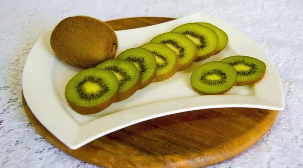 Kiwi fruit in white plate on  background — Stock Photo, Image