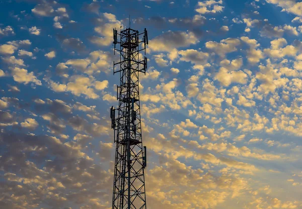 Telecommunication tower Antenna at sunset.