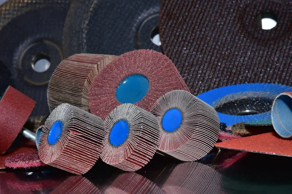 Flap Wheel. A pile of color abrasive sandpaper for metal working
