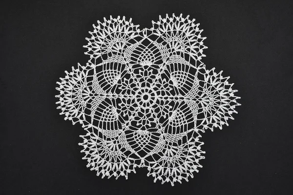 Crocheted lace napkin home decoration on black — Stock Photo, Image