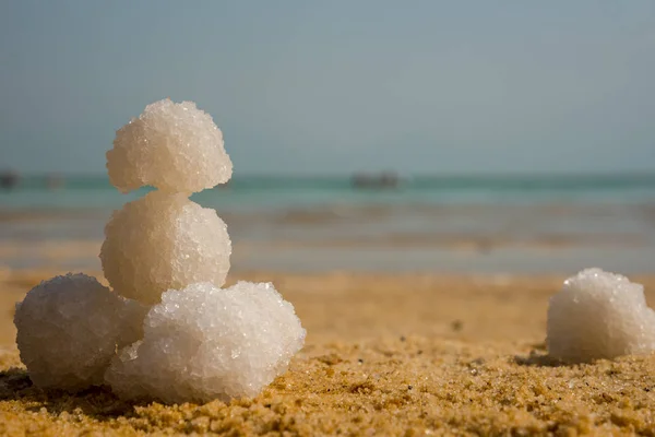 Relax balls of salt on the sand. Sky horizon. Sea. Sand.