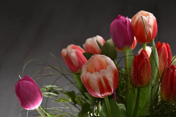 Bright spring flowers tulips bouquet on the table directly above view, colorful pink, red and yellow blooming tulips in vibrant colors Bouquet of tulips red-pink, red-yellow.