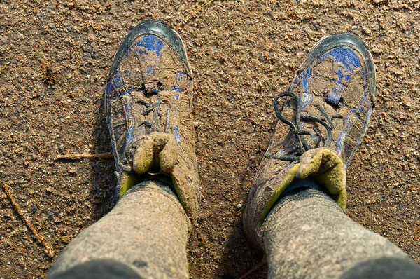 close up of man\'s boots while hiking on trail in the mountains