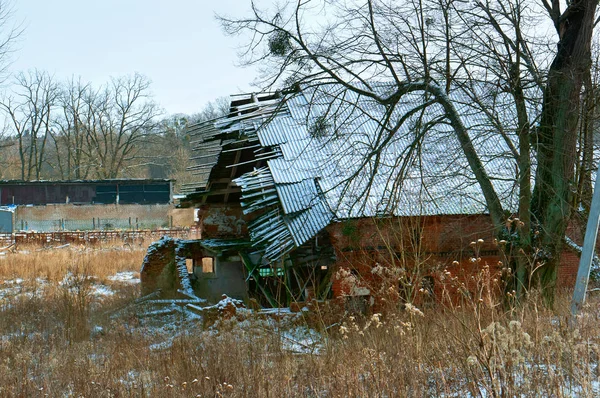 the old destroyed house, the broken collapsed roof of the house, the abandoned house, the walls and roof of the house were dilapidated and destroyed