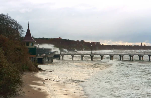 a severe storm in the Baltic sea, a storm at sea, the waves cover the pier