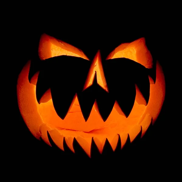 Halloween pumpkin face ghost glowing in the dark.