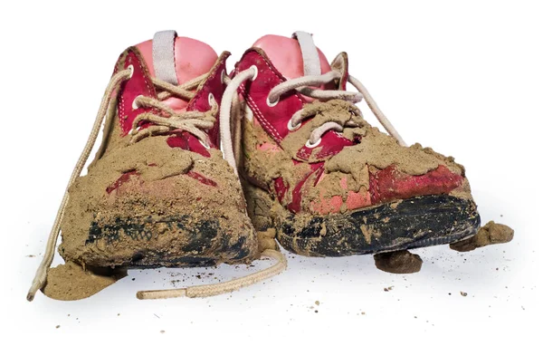 Детские крохотные туфли, покрытые грязью. Грязные леггинсы для детей Лицензионные Стоковые Изображения