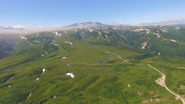 Панорама зеленых гор. Зеленая гора. Снег и трава в горах — стоковое видео