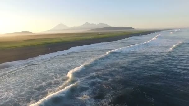 Vue aérienne. Survoler la mer au coucher du soleil. Montagnes dans le brouillard en arrière-plan — Video