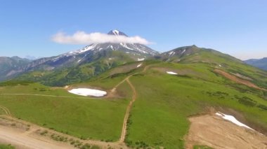 Havadan görünümü. Yeşil dağların etrafında uçan