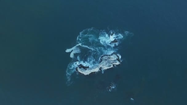 Légifelvételek óceán hullámai mosogatás rock, a szikla, a zátony. Egyenetlen ellen hullámok összeomlik — Stock videók